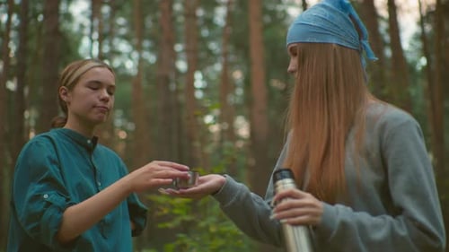 Friends Enjoy Peaceful Drink Together in Serene Forest