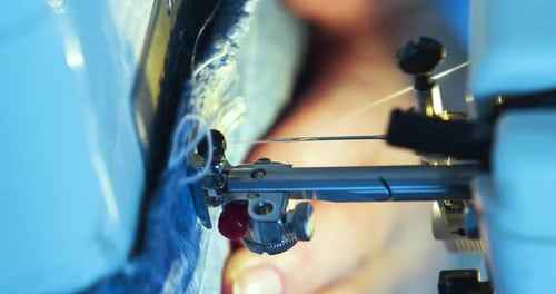 Vertical Video of a Female Hands Working on a Sewing Machine