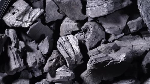 Black wooden charcoal texture background.