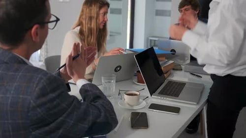 Professionals Collaborate at a Table During a Business Meeting