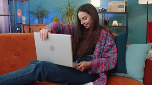 Young Woman Works on Laptop at Home