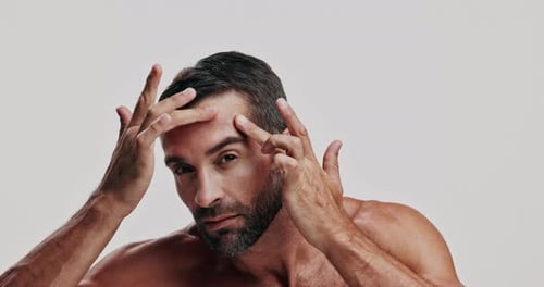 Face, inspection and skincare with man in studio for daily dermatology routine