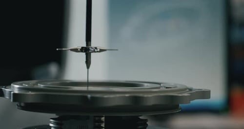 Slow motion macro of specialist is working on production of different gearing details in a worksho