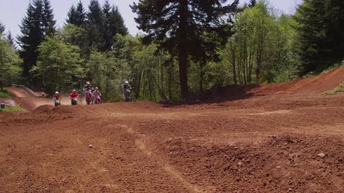Dirt Bike Riders Racing on Track in Nature
