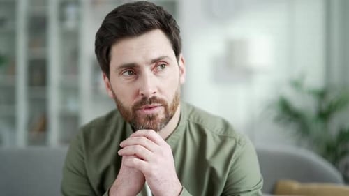 Pensive Man Smiling Indoors