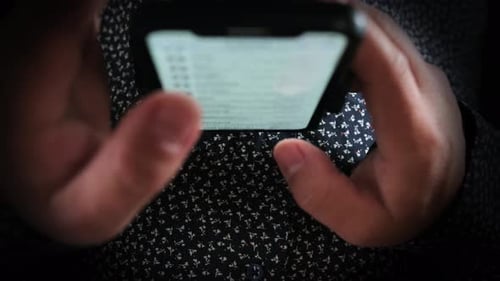 Hands of person typing and messaging in chat. Man use of mobile phone close-up.