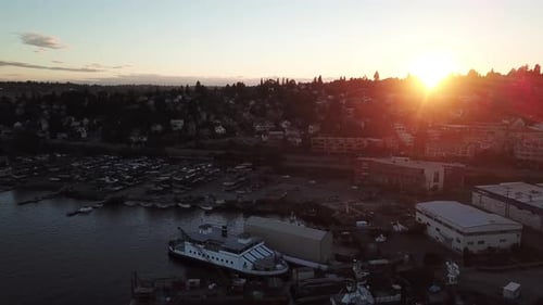 4k drone footage of a busy city located next to the coast during sunrise