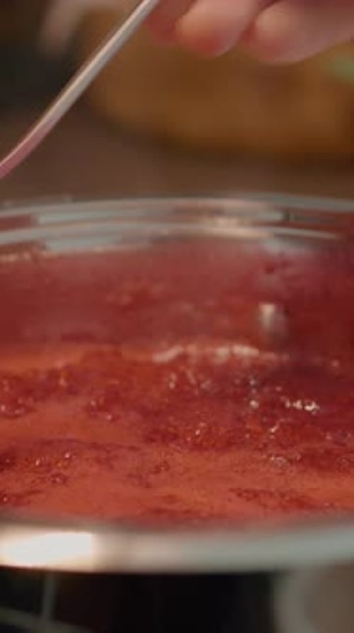 Red Jam Cooking in Silver Pot on Stove
