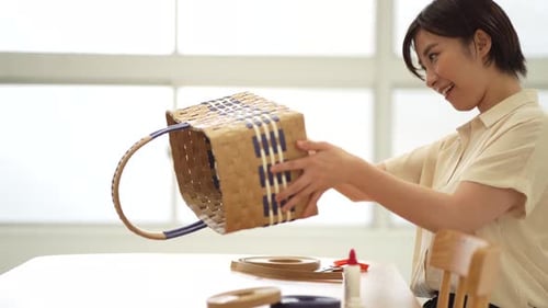 Woman Smiling at a Woven Basket She Created