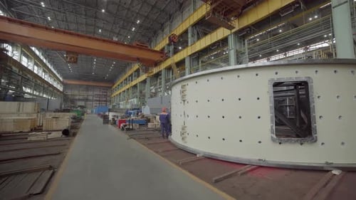 Workers building structure in factory industrial setting