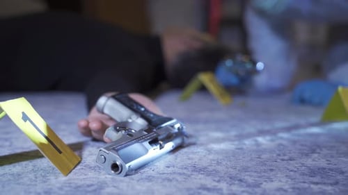 Man Lies Dead with Gun at Crime Scene