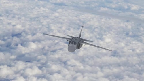 Military Transport Aircraft Flying Above Fluffy Clouds