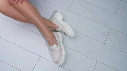 Woman Showing off Cream Shoes Inside Studio