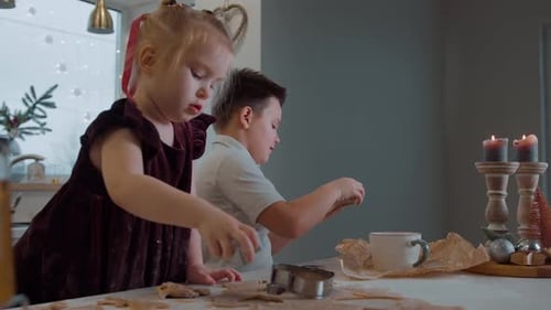 Two Children Making Christmas Cookies Together
