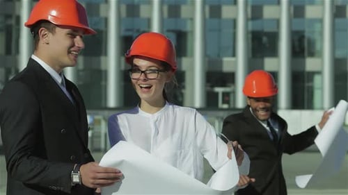 Architects Reviewing Blueprints at Construction Site