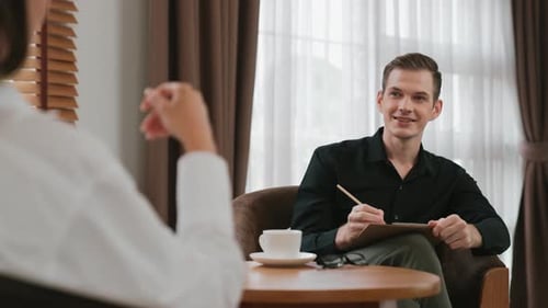 Man Listens to Woman in Consulting Session