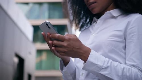 Focused African American Business Woman Typing Cellphone Close Up in City Businesswoman Female