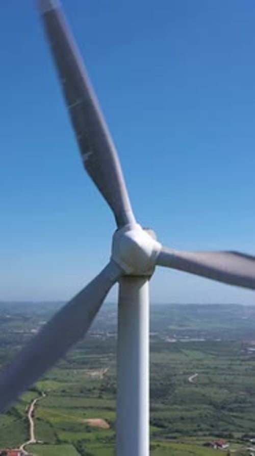 Wind Turbine with Blades in Green Rural Area on Sunny Day Aerial View Vertical Video