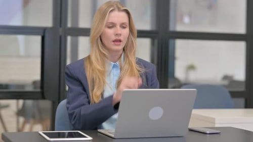 Woman Working on Laptop Coughing in Office