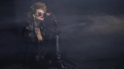 Blonde Woman in Leather Outfit Poses in Smoke