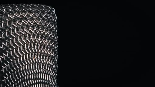 The Studio Condenser Microphone Rotates on a Black Background CloseUp