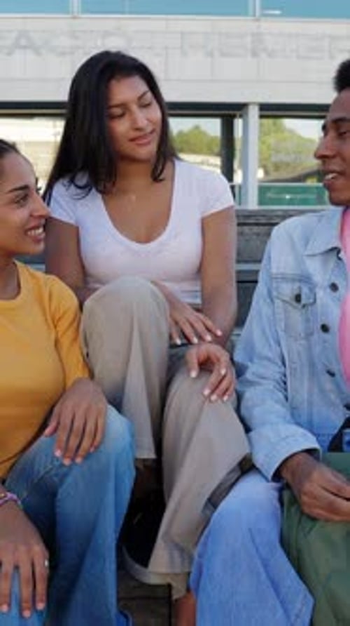 Young Group of Gen Z College Students Hanging Out Sitting on Staircase at Campus