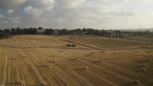 Aerial video above a tractor harvesting wheat in Even Yehuda Israel