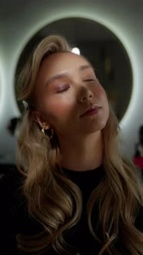 Glamorous Woman with Long Hair Posing in Studio