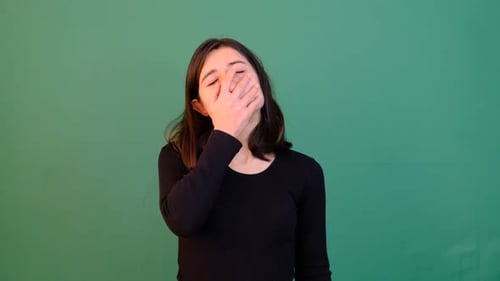 Stressed Young Woman Covering Face in Despair