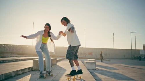 Happy Pair Riding Skate Boards Sunny Stadium Carefree Couple Enjoying Summer