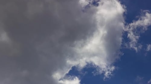 Fluffy White Clouds Drifting Across a Blue Sky