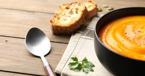 Bright Pumpkin Soup Garnished with Parsley and Croutons
