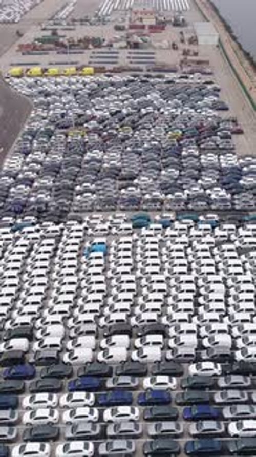 Vertical Video of new cars parked in harbor