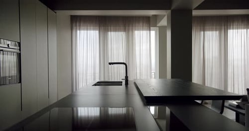 Modern apartment kitchen with island and large windows