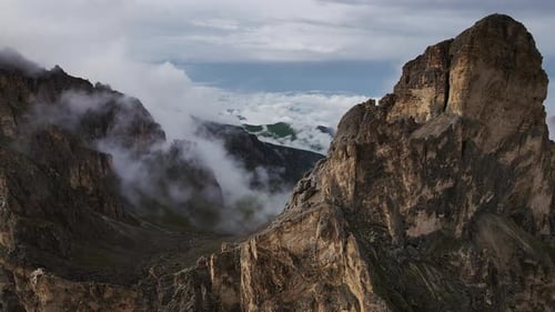 A Pass in the Mountains Behind Which Clouds Fly in the Valley in the Lowland