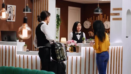 Hotel Guest Checking in With Hotel Staff