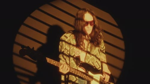 Indie Musician Playing the Guitar and Rocking in Yellow Spotlight