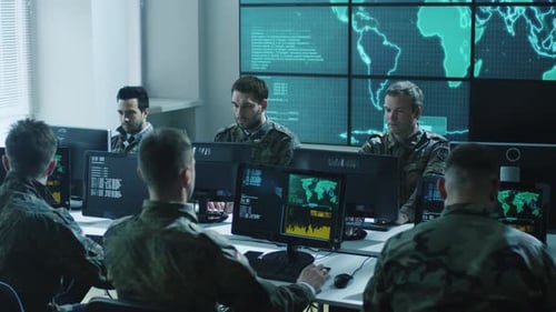 Men Wearing Camouflage Working at Computers in Office