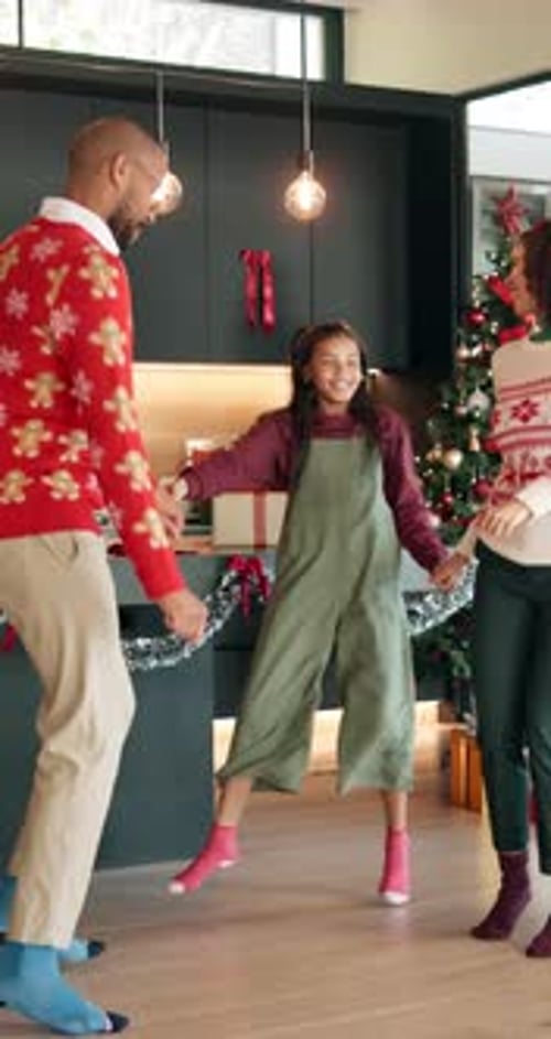 Family Dancing Together Near Christmas Tree Indoors