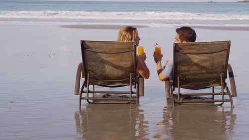 Couple with Tropical Cocktails at Beach. on Red Epic for High