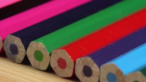 Colorful pencils rotate as a background. Rainbow pencils for drawing. Assortment of colored pencil