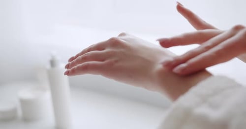 Woman Applies Lotion for Beautiful Skin