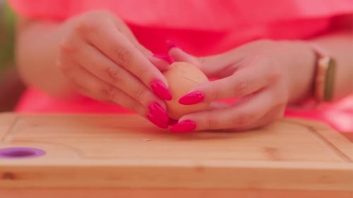 Woman's Hands Peeling a Hard Boiled Egg