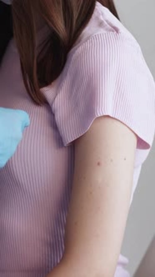 Medical Professional Applies Bandage to Patient's Arm