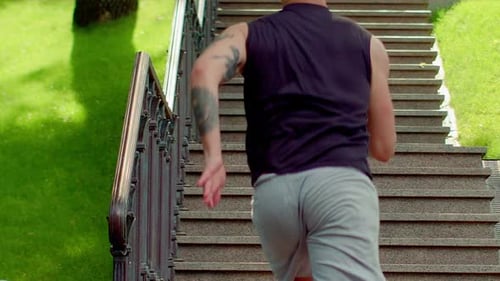 Man Jogging Up Stairs in Urban Park Setting