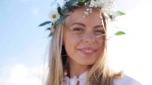 Smiling woman wearing floral crown outside
