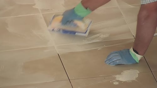Cleaning Beige Tile Floor with Cleaning Tool