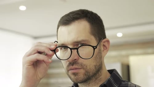 Man Removing Glasses Looks Shocked and Surprised