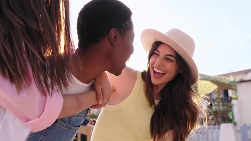 Slow Motion Small Multiethnic Group Smiling Young Women Enjoying Together Piggybacking Down Street