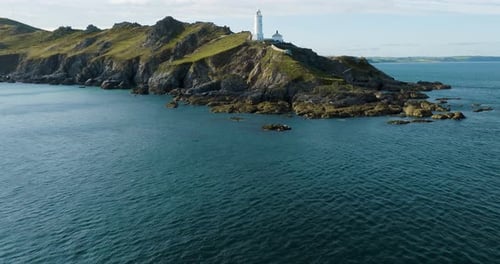 Flying Over A light House Along A Stunning Rocky Coastline In Summer Drone Shot